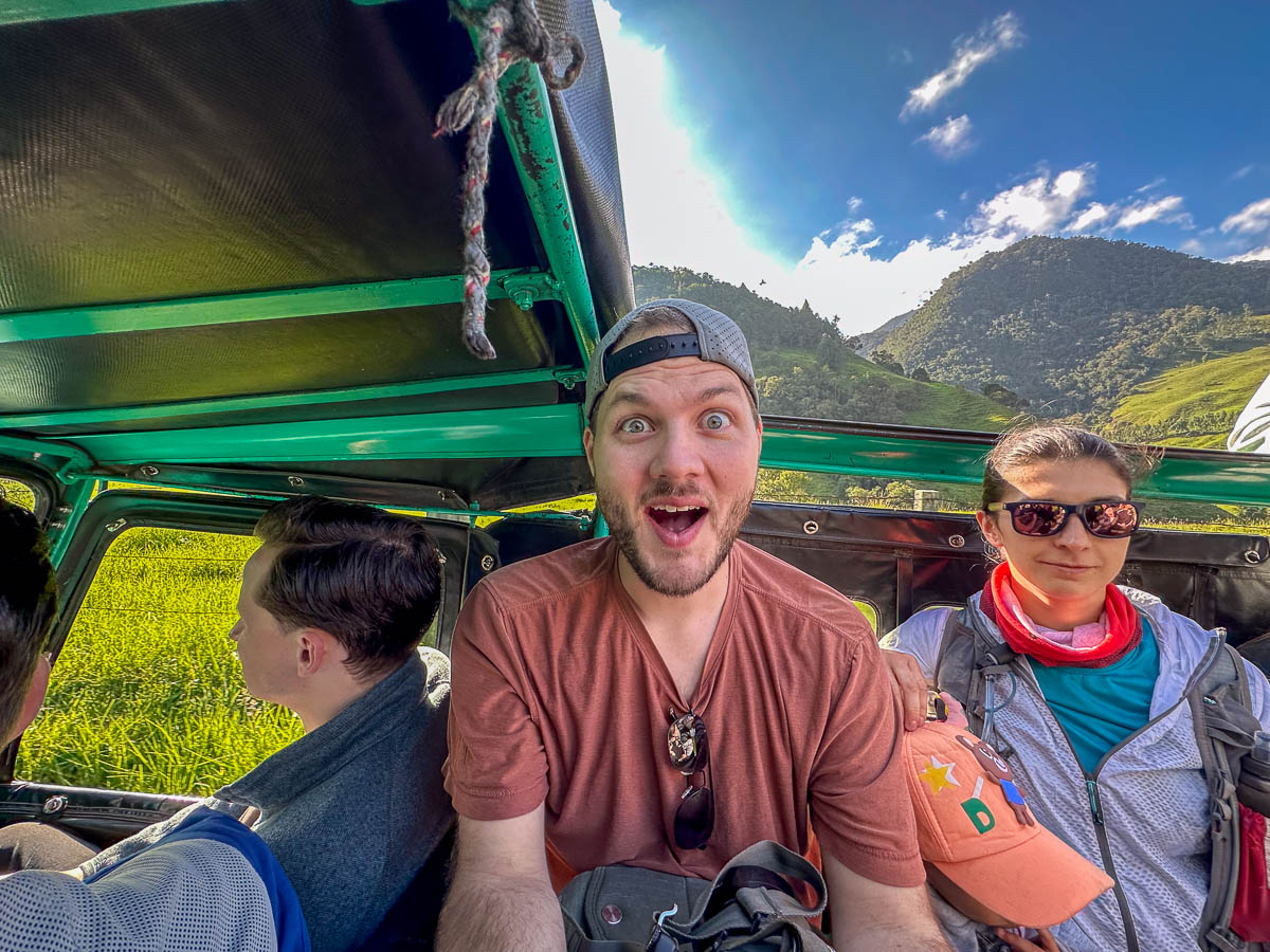 Man sitting in the back of a Willy while driving through the Cocora Valley in Salento, Colombia