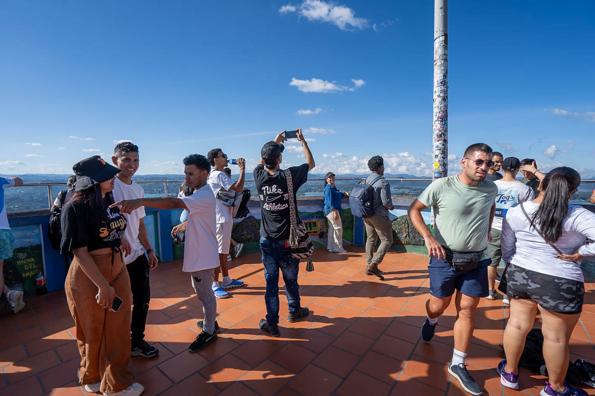 People standing at the lookout for The Rock in Guatape, Colombia