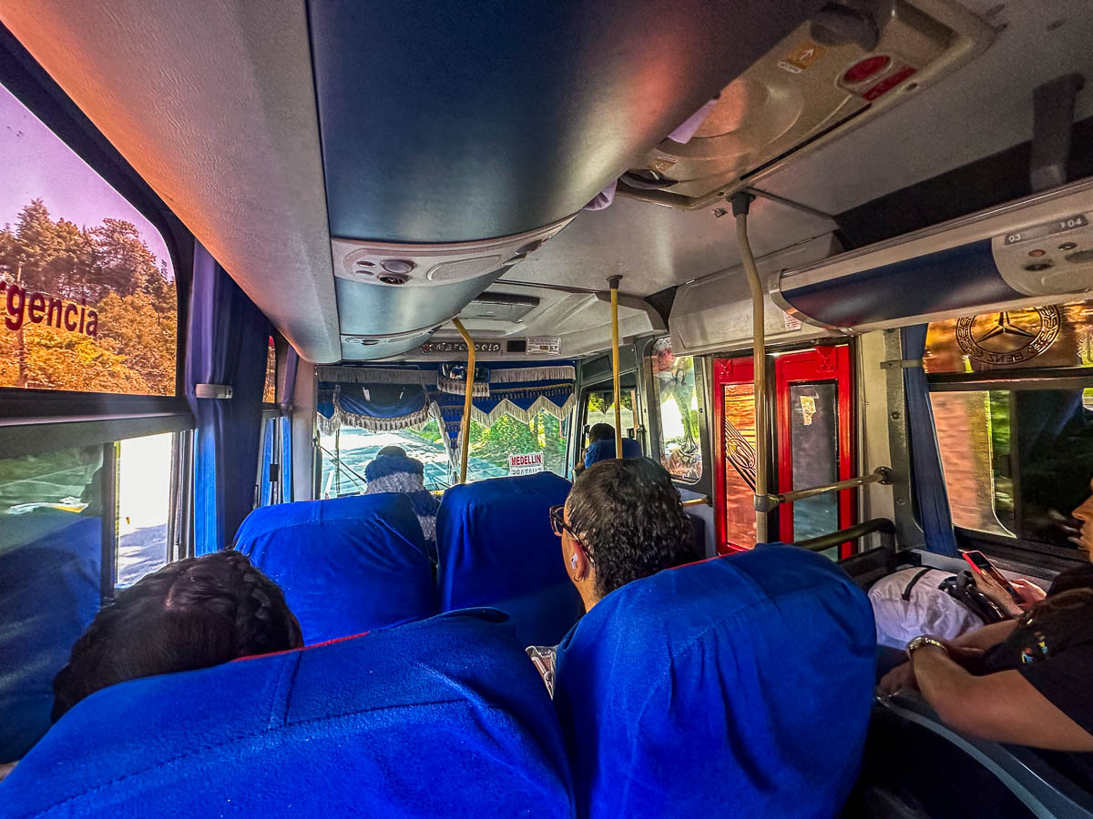 Passengers sitting on a bus heading to Guatape, Colombia