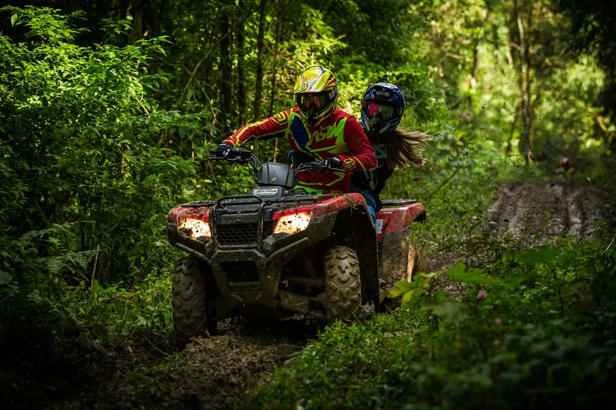 Couple riding on an ATV through the jungle