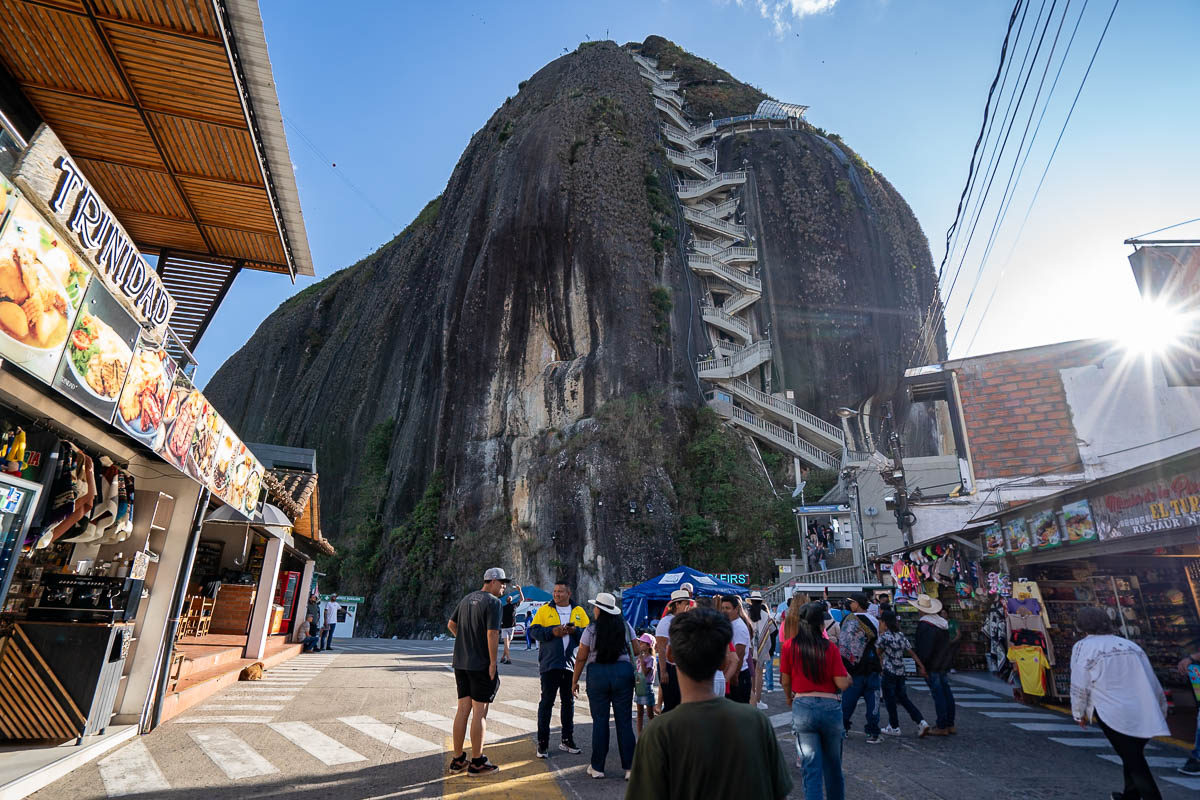 Crowds standing at the base of Piedra el Penol in Guatape, Colombia