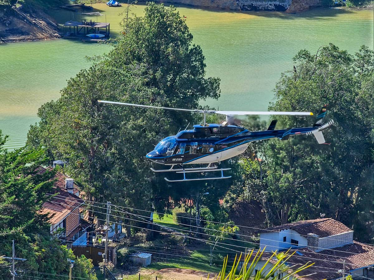 Helicopter flying above the Guatapé-El Peñol Reservoir near Piedra el Penol near Guatape, Colombia