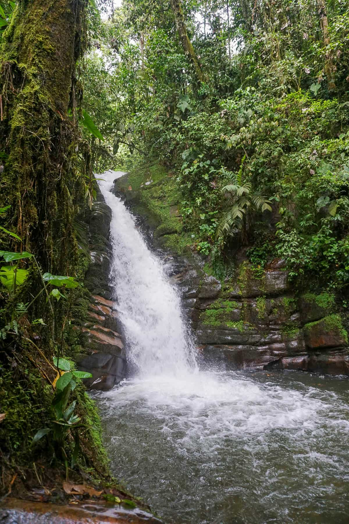 Waterfall down a rocky cliffside in Salento, Colombia