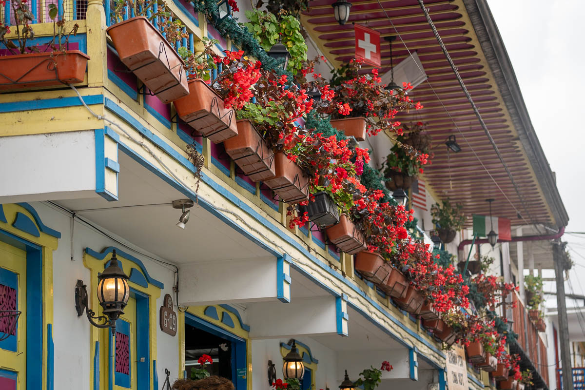 Flower boxes hanging off a colorful building in Salento, Colombia 