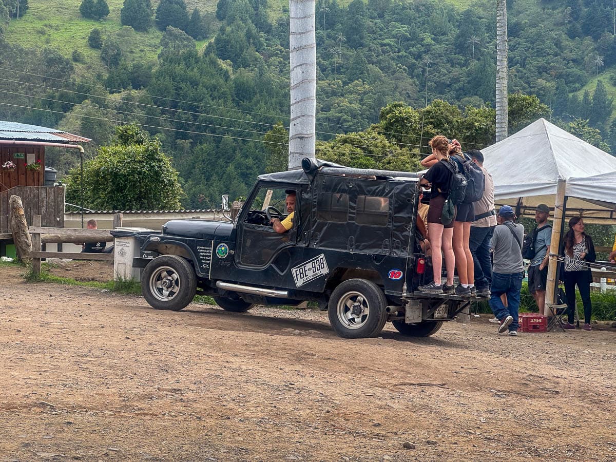 Travelers standing on the back of a Willie, leaving the Cocora Valley in Salento, Colombia