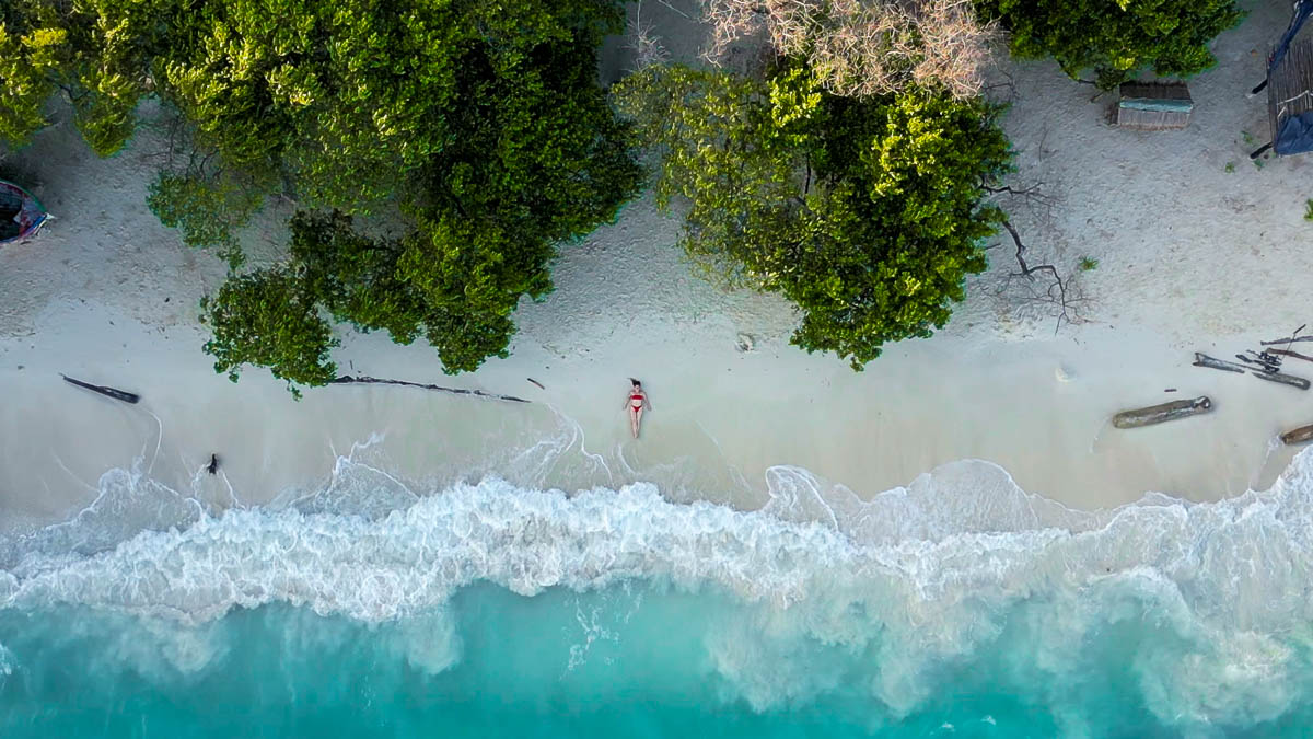 Woman laying on Playa Libre on Isla Grande in Colombia
