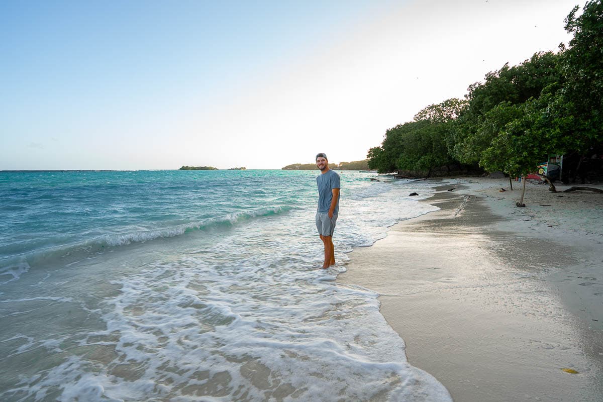 Man standing on Playa Libre with on Isla Grande in Colombia