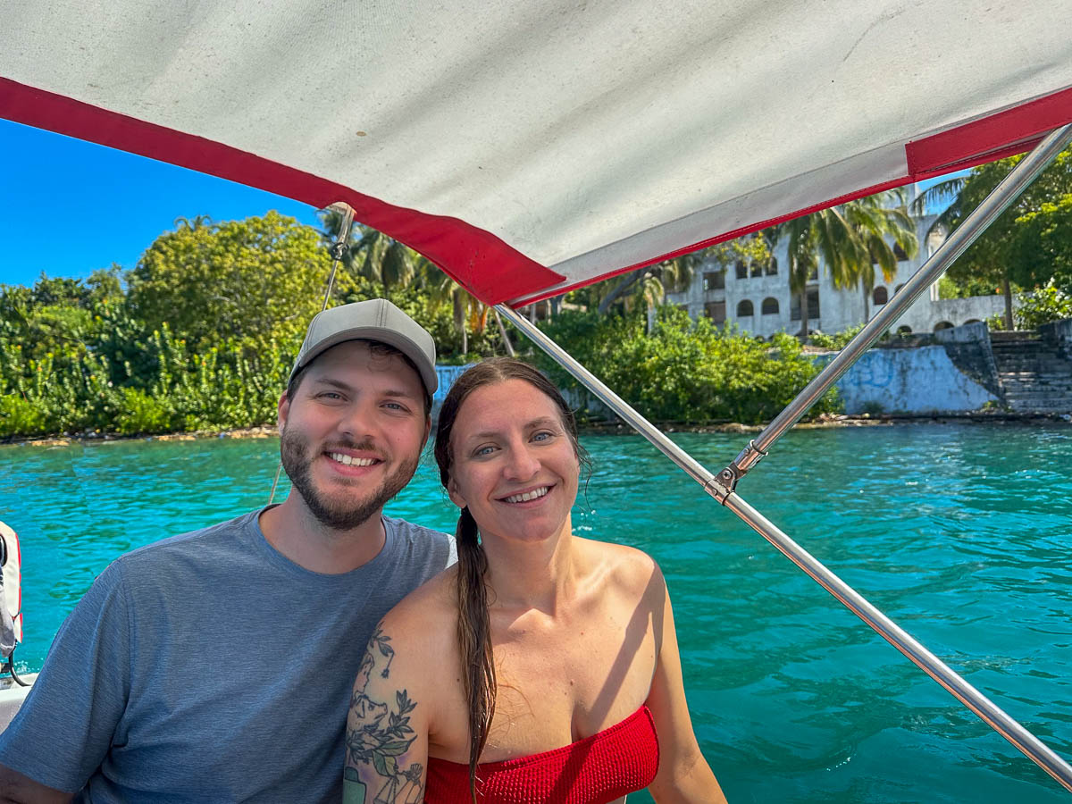 Couple sitting on a boat in front of Casa Grande on Isla Grande in Colombia