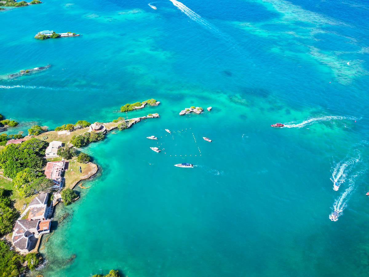 Aerial view of buoys and boats circling around Pablo Escobar's sunken plane in the Caribbean Sea on Isla Grande in Colombia