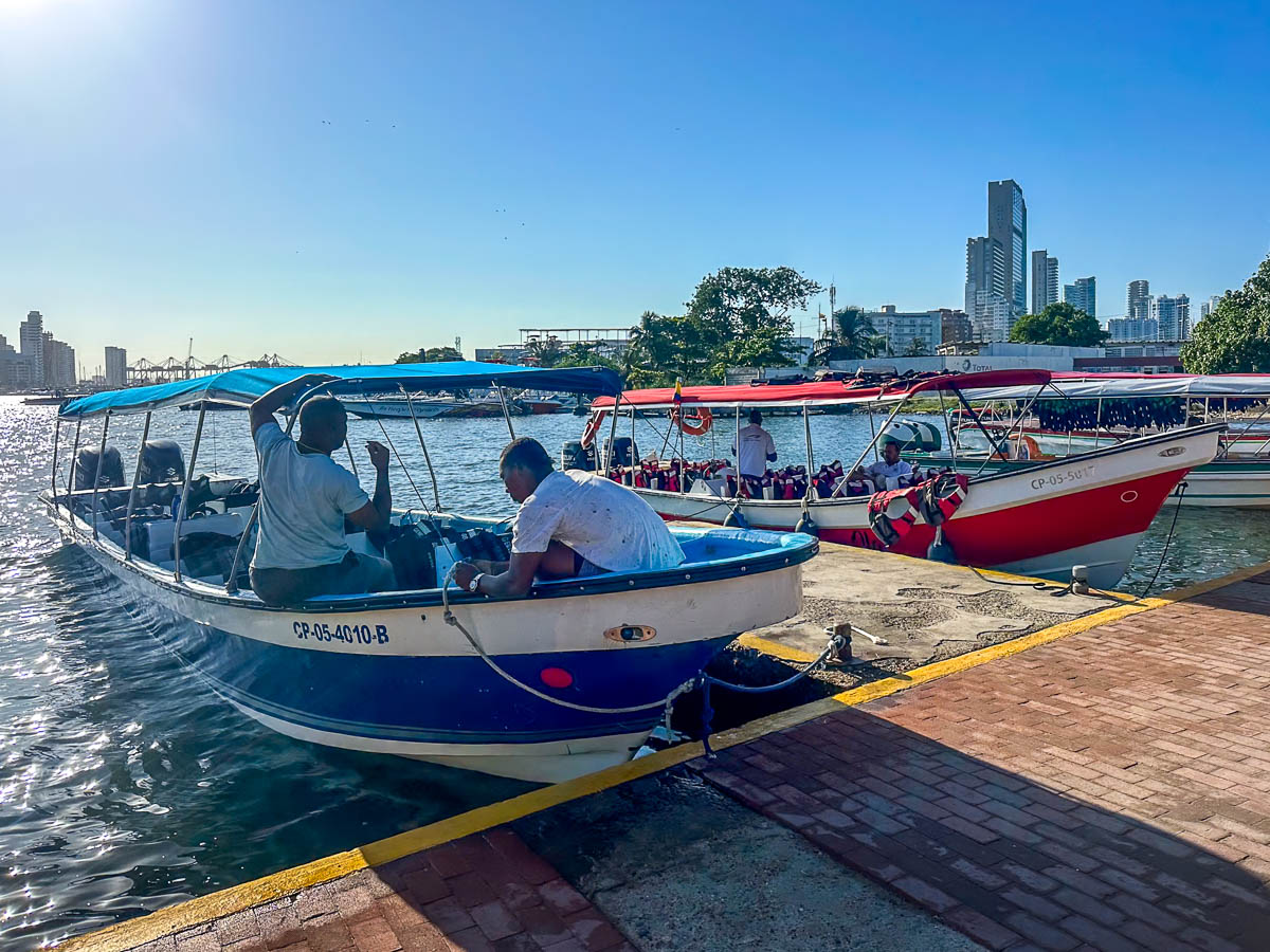 Drivers sitting on water taxis in the Port of Cartagena in Colombia