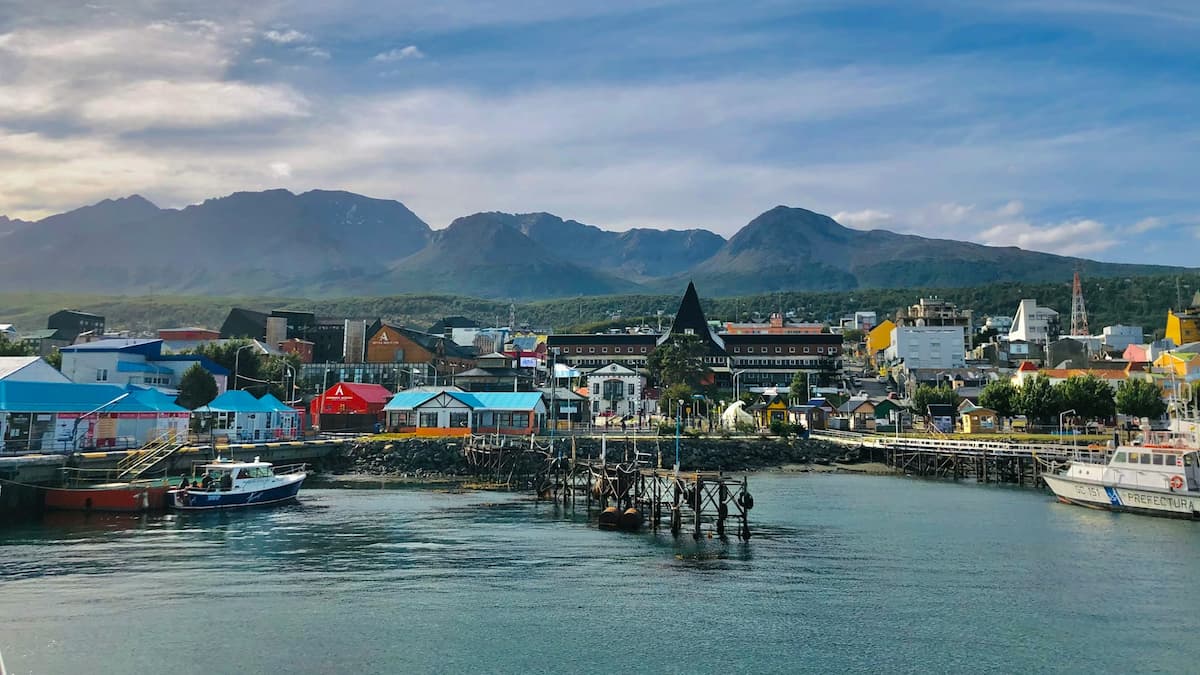 View of colorful buildings with mountains in the background of the port of Ushuaia, Argentina