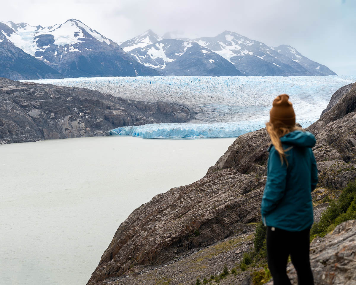 Woman looking at Glacier Grey from Mirador Grey along the Glacier Grey Trail in Torres del Paine National Park in Chile