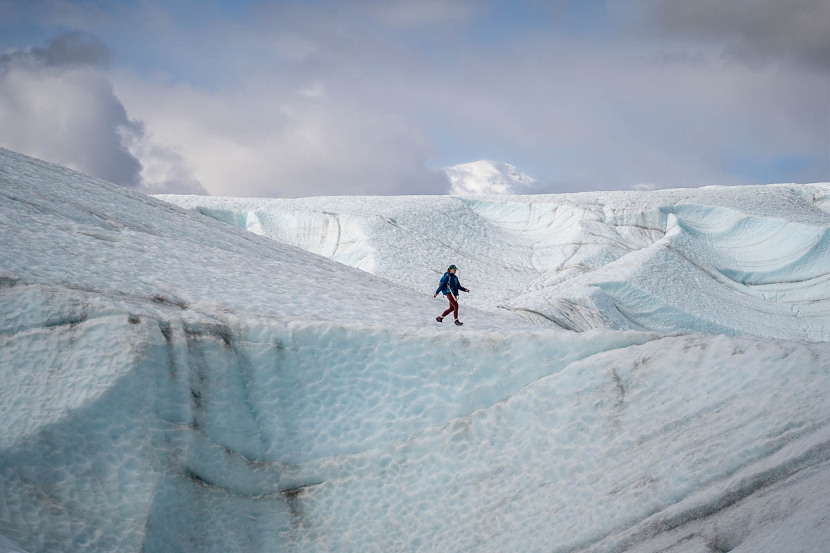 Woman walking on the Root Glacier in Wrangell-St. Elias National Park in Alaska