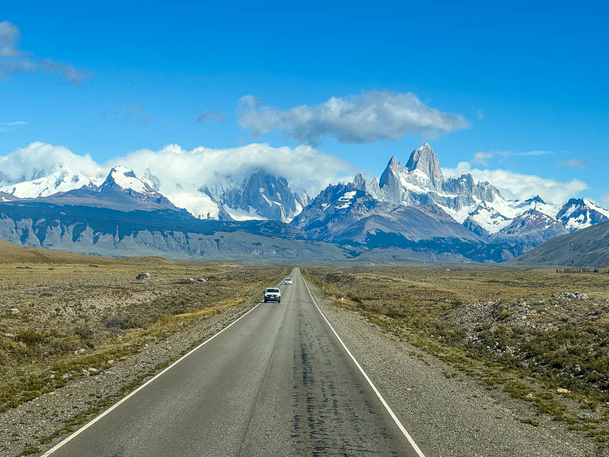 Cars driving along Ruta 23 with Mount Fitzroy in the background in El Chalten, Argentina