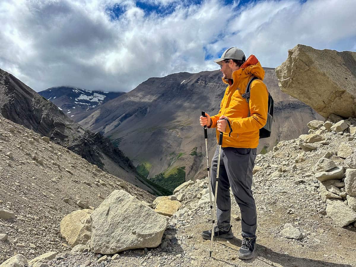 Man standing on a ridgeline with a mountain in the background along the Mirador Base las Torres Trail in Torres del Paine National Park in Chile