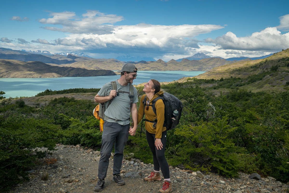 Couple standing in front of Nordenskjöld Lake along the W Trek in Torres del Paine National Park in Chile