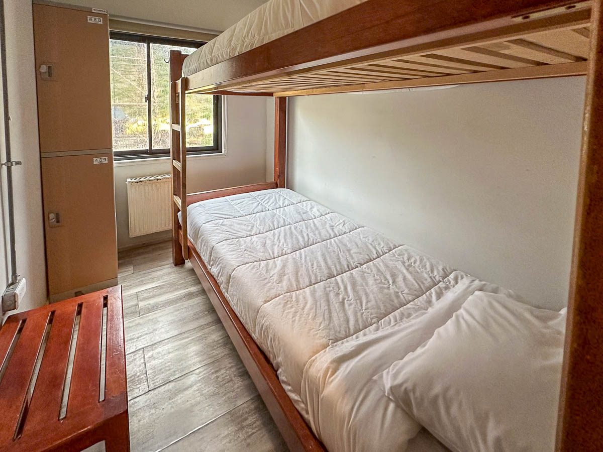 Dorm hostel in bunk beds and lockers in Refugio Paine Grande in Torres del Paine National Park in Chilean Patagonia