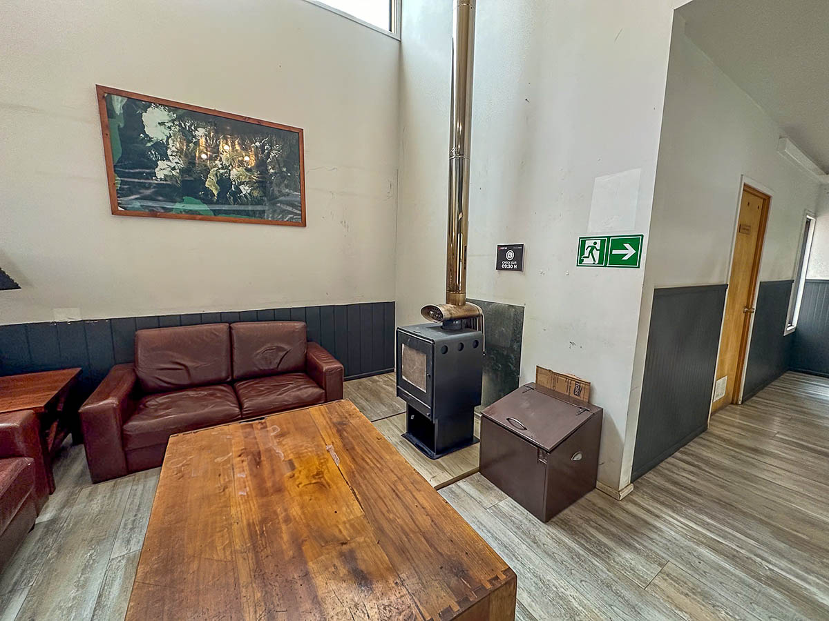 Lounge area with a fireplace in Refugio Paine Grande in Torres del Paine National Park in Chilean Patagonia