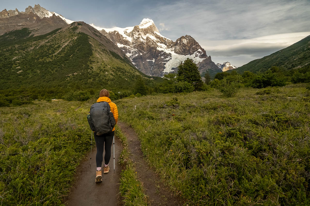 Woman hiking towards the Paine Grande mountain with the French Glacier along the W Trek in Torres del Paine National Park in Chilean Patagonia