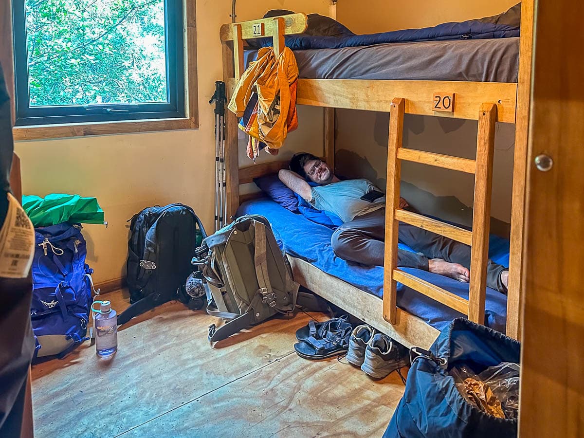 Man laying on a bunk bed in Refugio Cuernos along the W Trek in Torres del Paine National Park in Chilean Patagonia