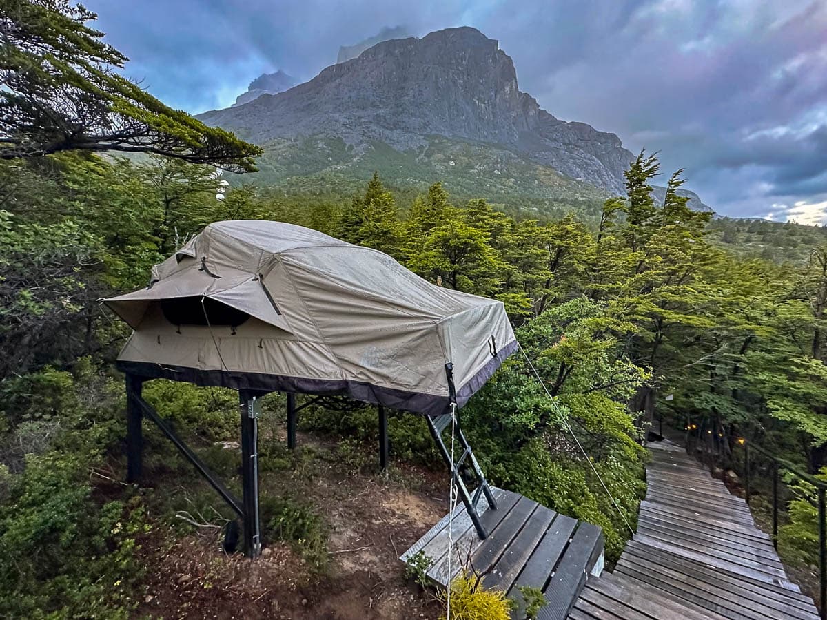 Tent platform along a wooden boardwalk in Refugio Frances with a mountain in the background along the W Trek in Torres del Paine National Park in Chilean Patagonia