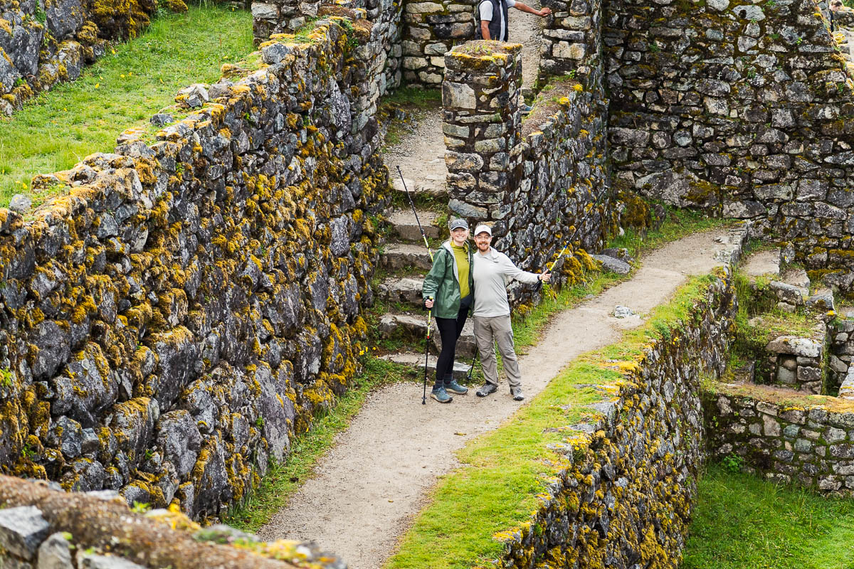 Couple standing near a staircase at Sayacmarca ruins along the Inca Trail in Peru