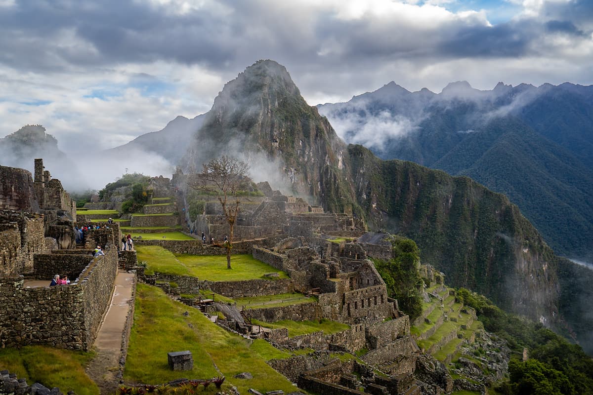 Machu Picchu Inca ruins with moody clouds in the background in Peru