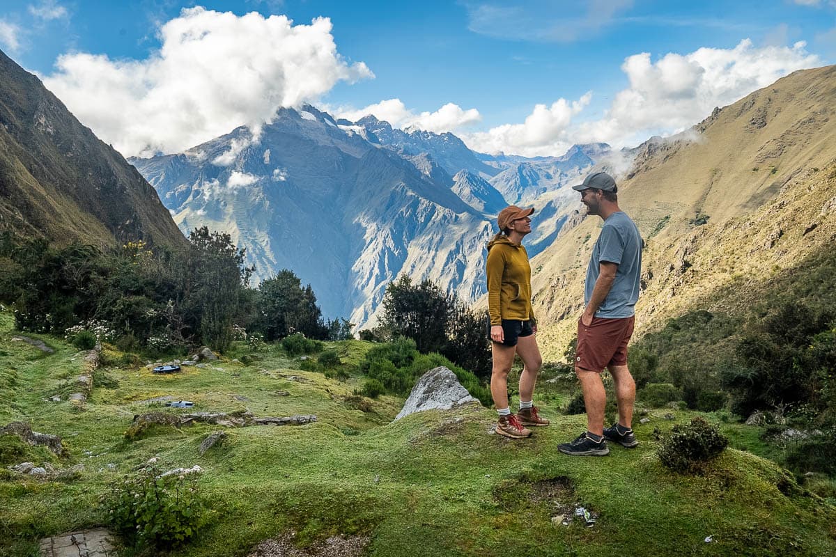 Smiling couple with Andes Mountains in the background along the Inca Trail in Peru