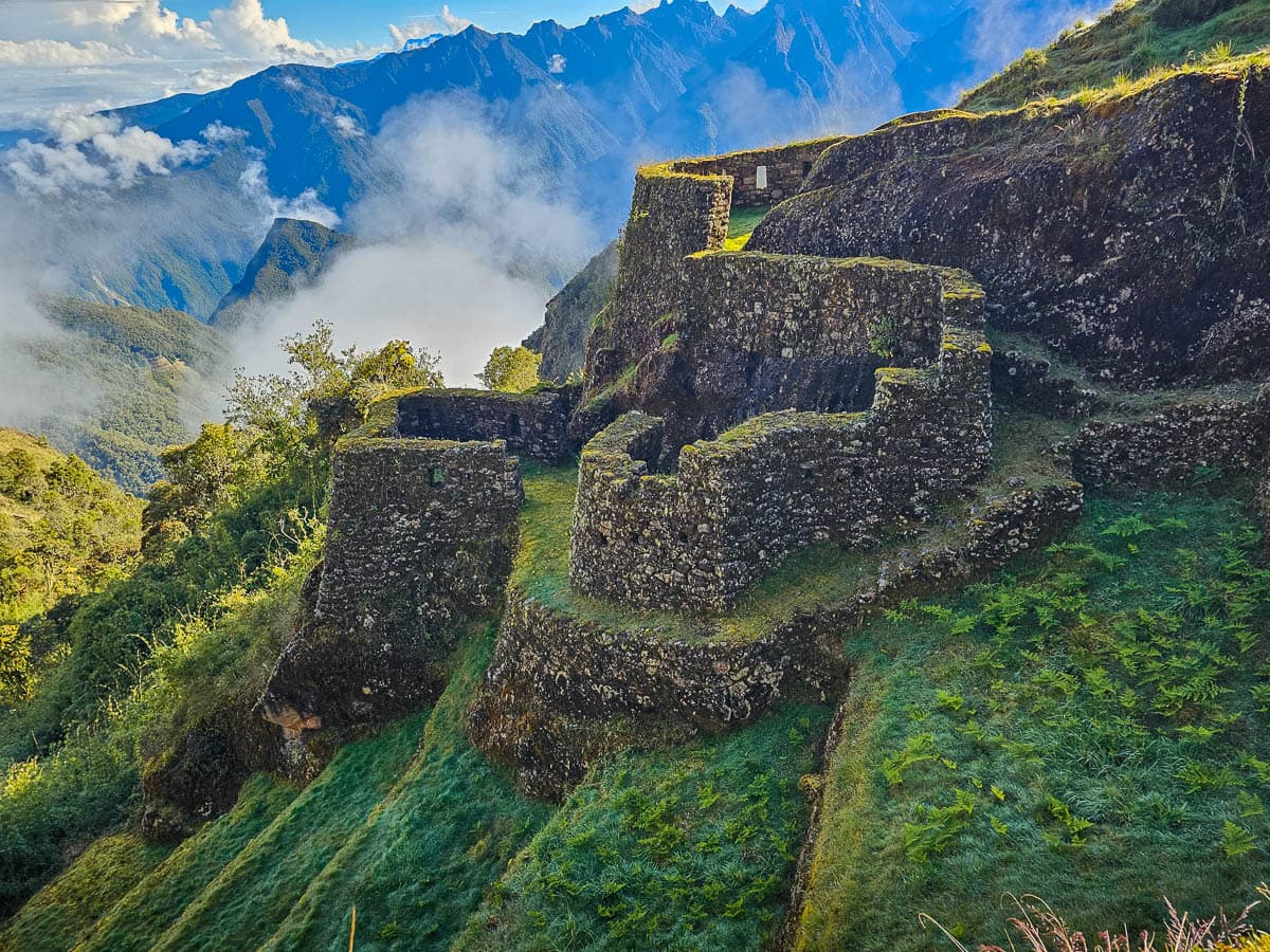 Phuyupatamarca with mountains and clouds in the background along the Inca Trail in Peru