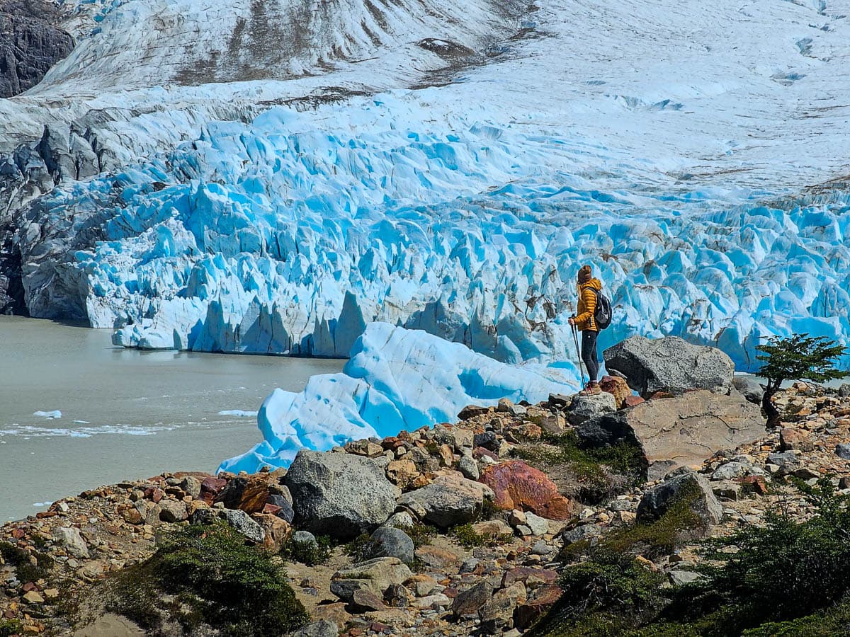 Woman standing in front of Glacier Grande along the Laguna Torre Trail in El Chaltén in Argentinian Patagonia