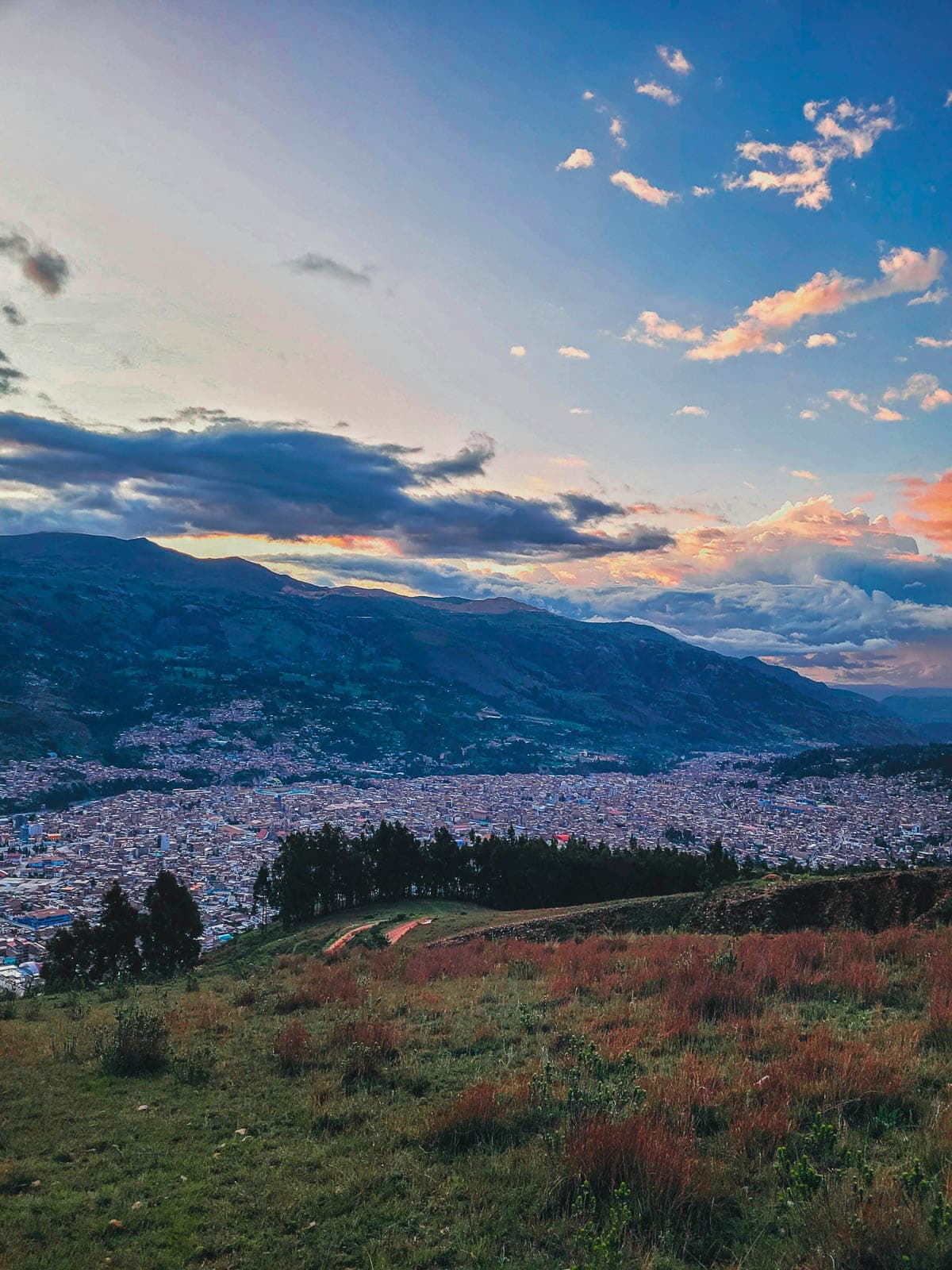 View of the city of Huaraz with mountains behind it at sunset in northern Peru