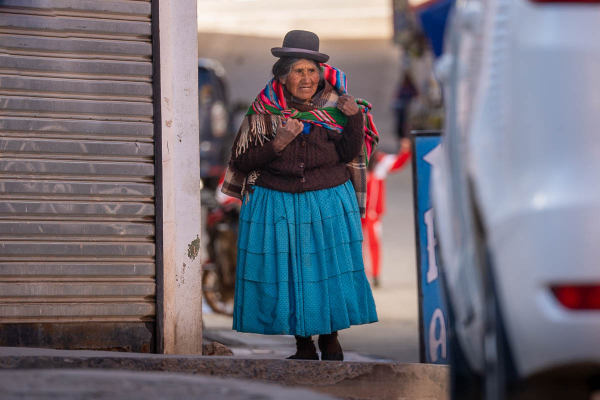 Cholita woman walking down a street in Copacabana, Bolivia