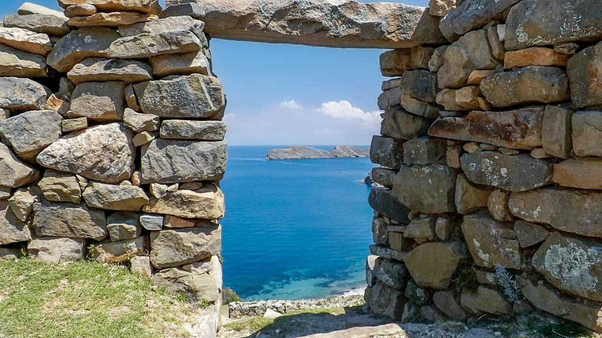 Doorway in an Inca ruin with Lake Titicaca in the background in Isla del Sol, Bolivia