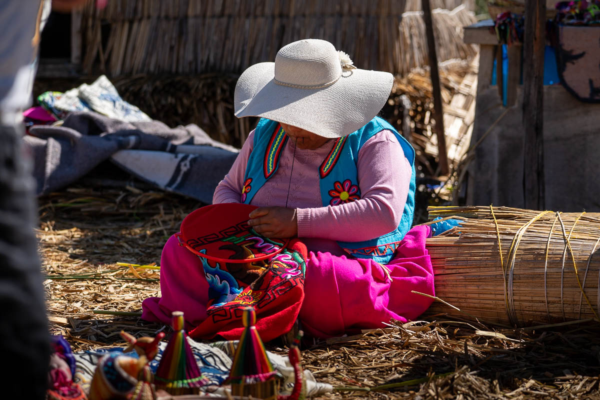 Woman embroidering on a reed island in the Uros islands near Puno, Peru