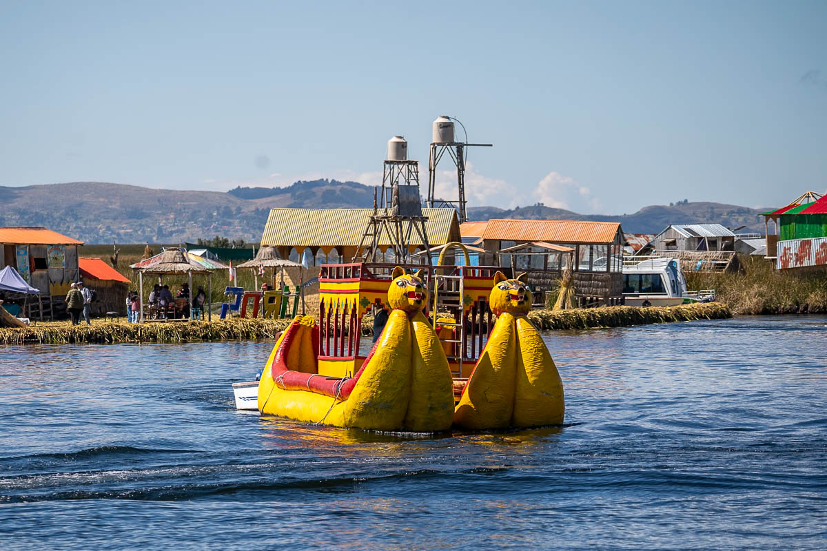 Traditional balsa boats with Uros islands in the background near Puno, Peru