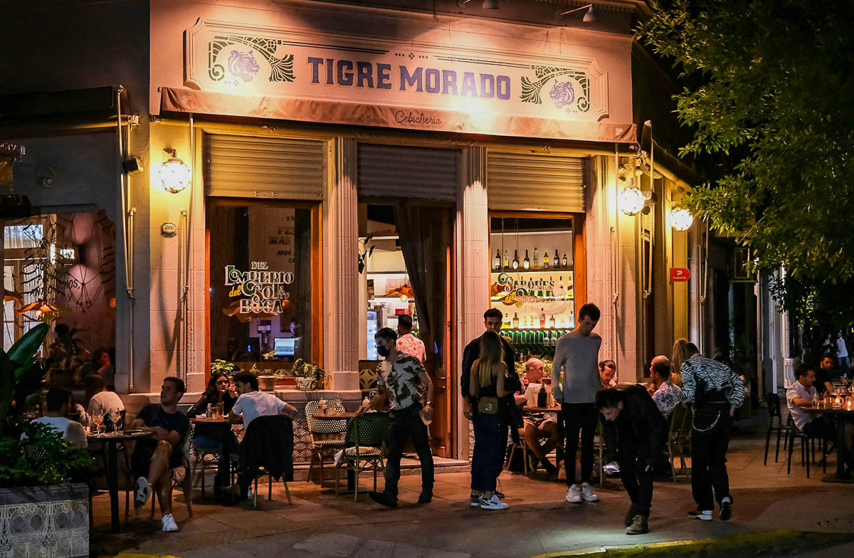 People hanging out in front of a restaurant in the Polermo neighborhood in Buenos Aires, Argentina