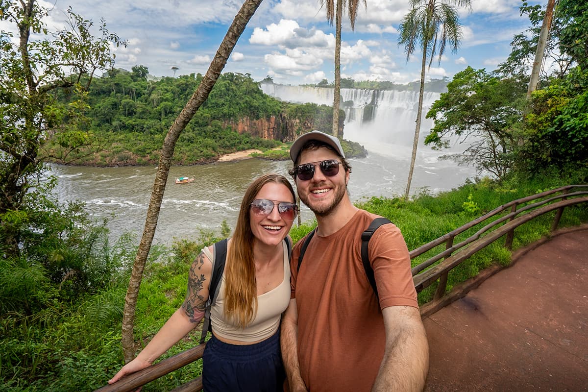 Smiling couple in front of Iguazu Falls, Argentina