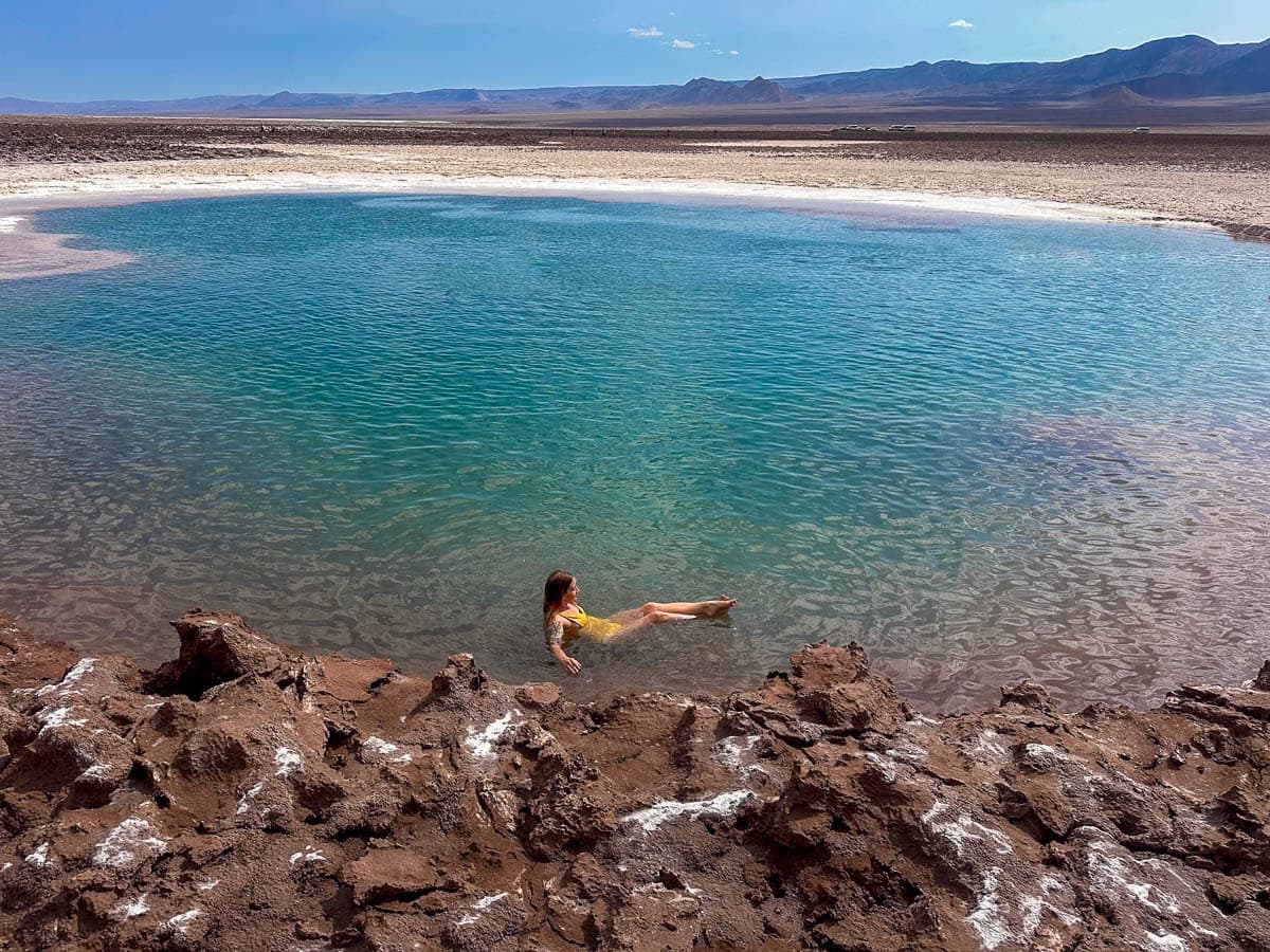 Woman floating in a turquoise lagoon in the Lagunas Escondidas de Baltinache in the Atacama Desert in Chile