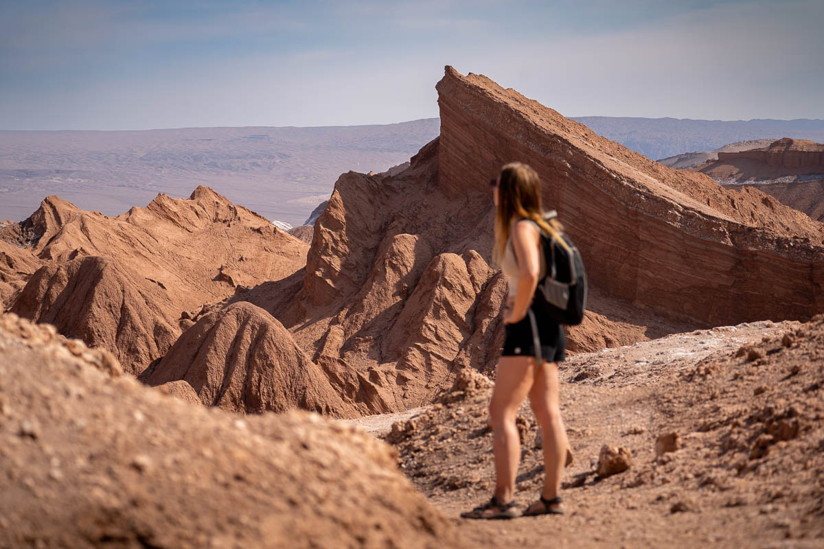 Woman looking at dramatic rock formations in Valle de la Luna near San Pedro de Atacama in the Atacama Desert in Chile