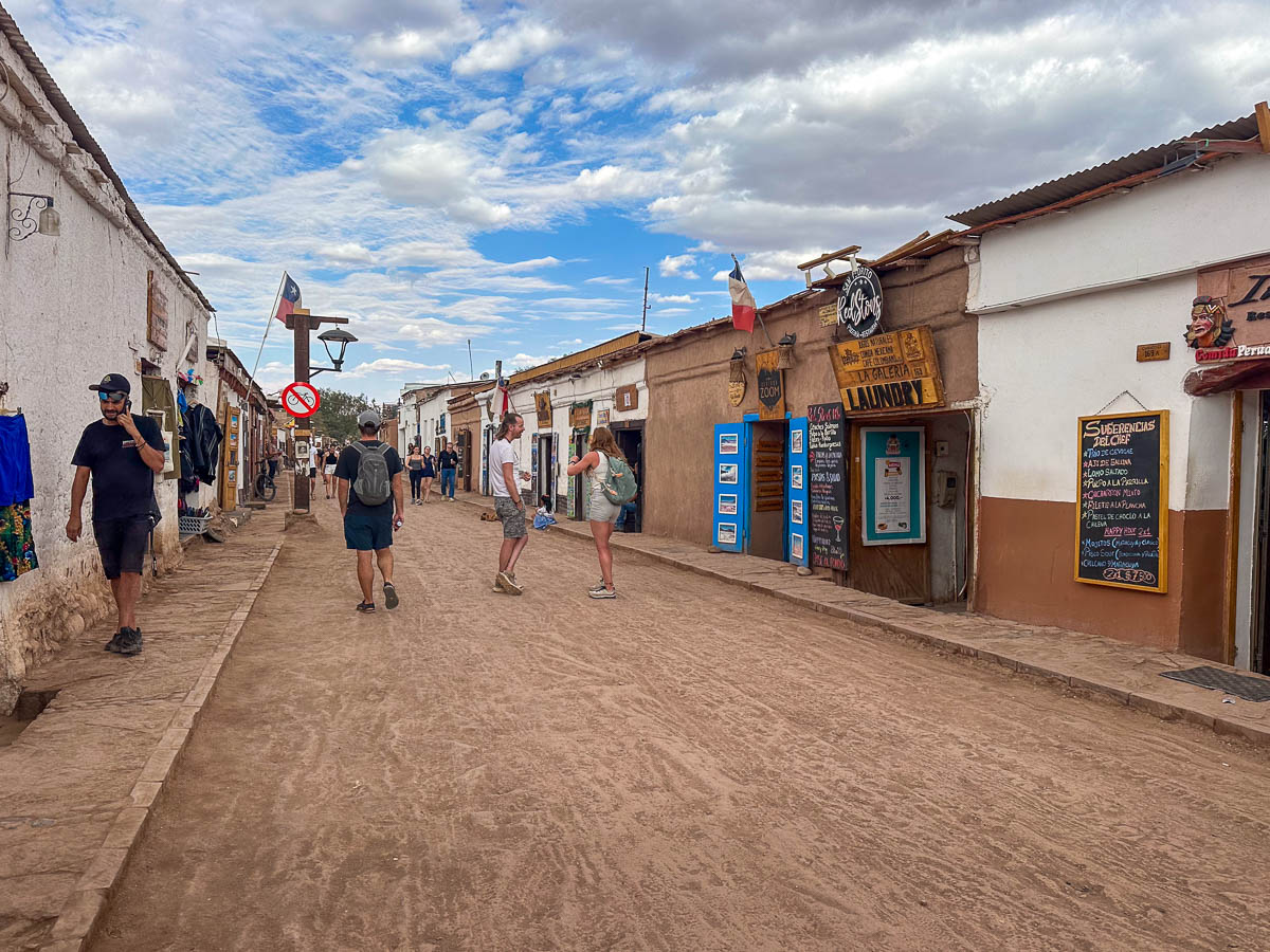 People walking down the dusty street of San Pedro de Atacama in the Atacama Desert, Chile