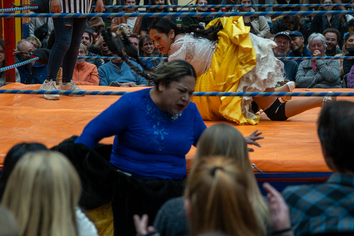 Two cholitas fighting in a wrestling ring at a Cholita Wrestling show in La Paz, Bolivia