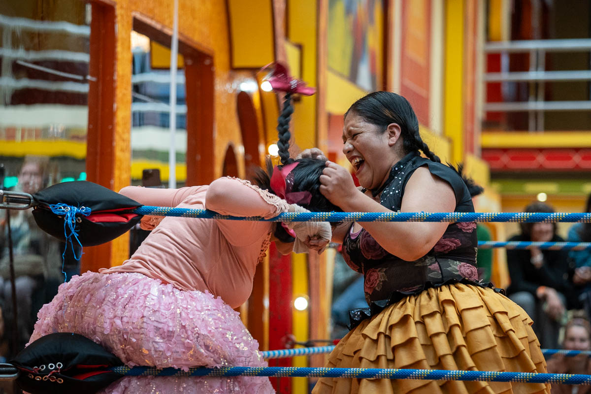 Two women fighting in a wrestling rink at a Cholita Wrestling show in La Paz, Bolivia