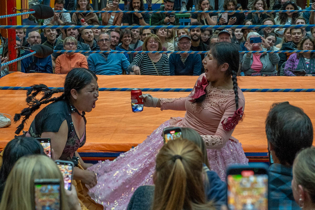 Two cholitas fighting with a beer can at a Cholita Wrestling show in La Paz, Bolvia
