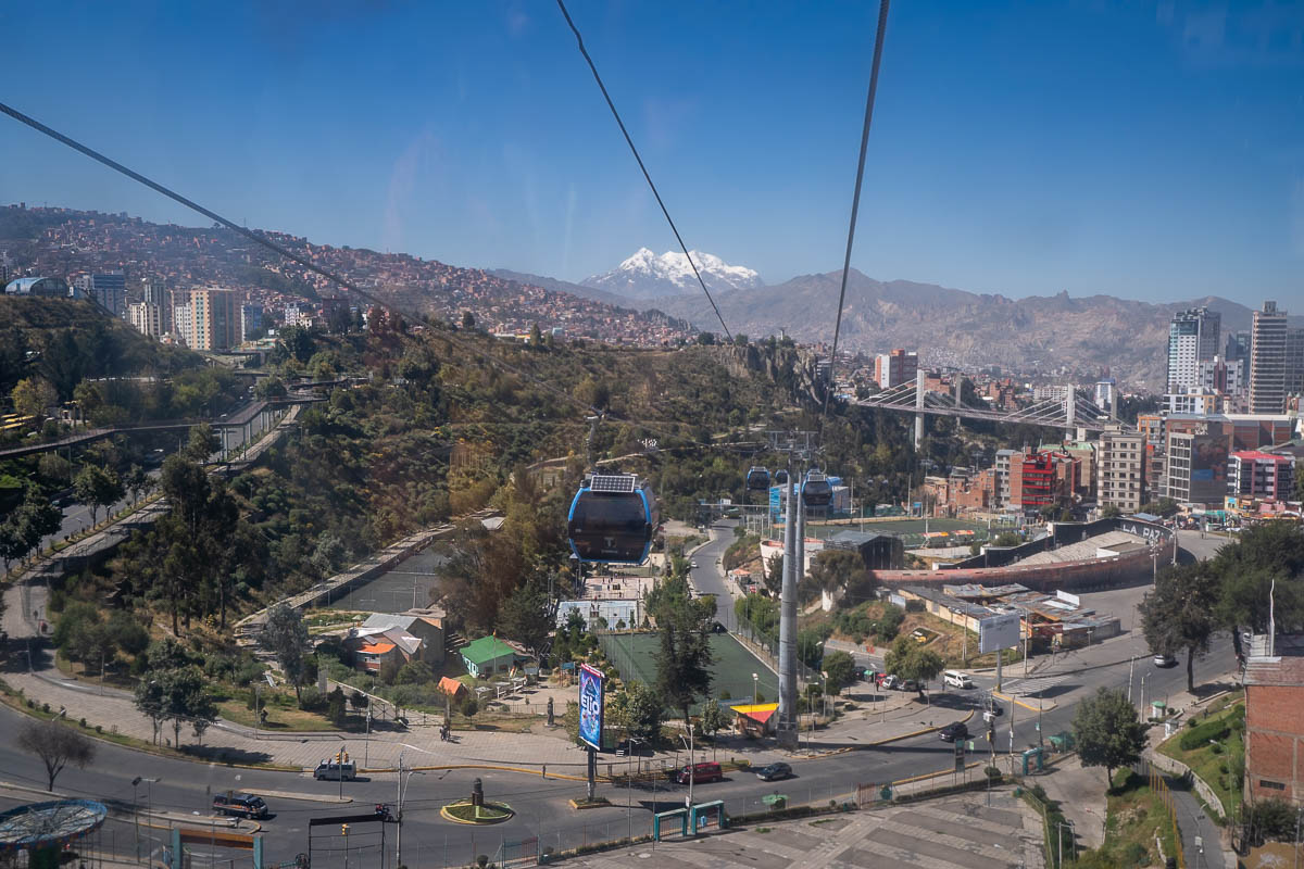 Mi Teleférico aerial tram above La Paz, Bolivia with a snow-capped mountain in the background