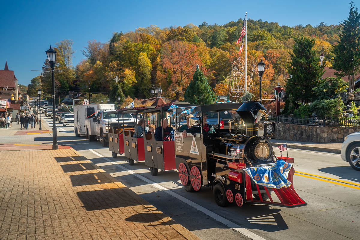 Steam train tram with fall foliage in the background in Helen, Georgia