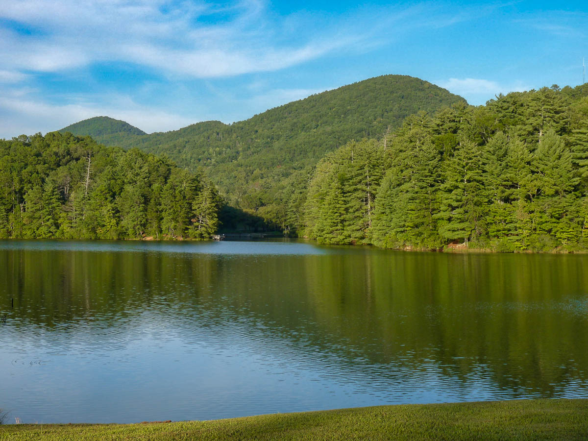 Unicoi Lake surrounded by hills covered in pine trees, located in Unicoi State Park near Helen, Georgia