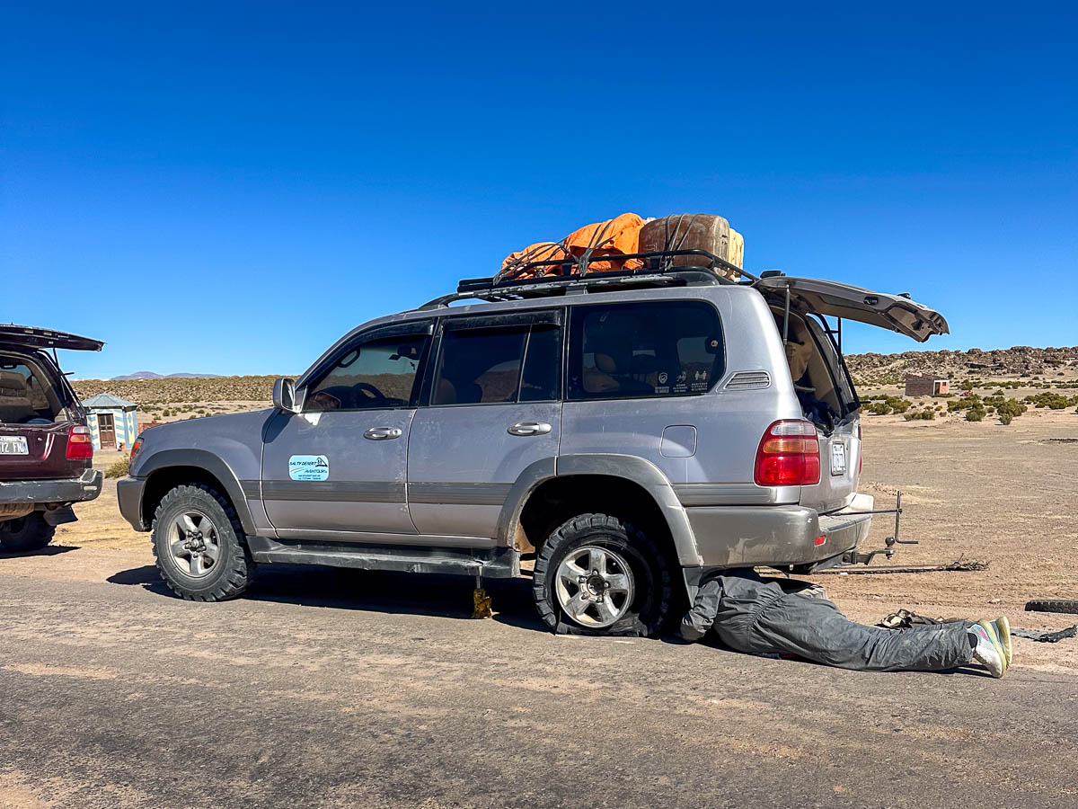 Man fixing a Toyoa Land Cruiseer on a Uyuni Salt Flats tour in Uyuni, Bolivia