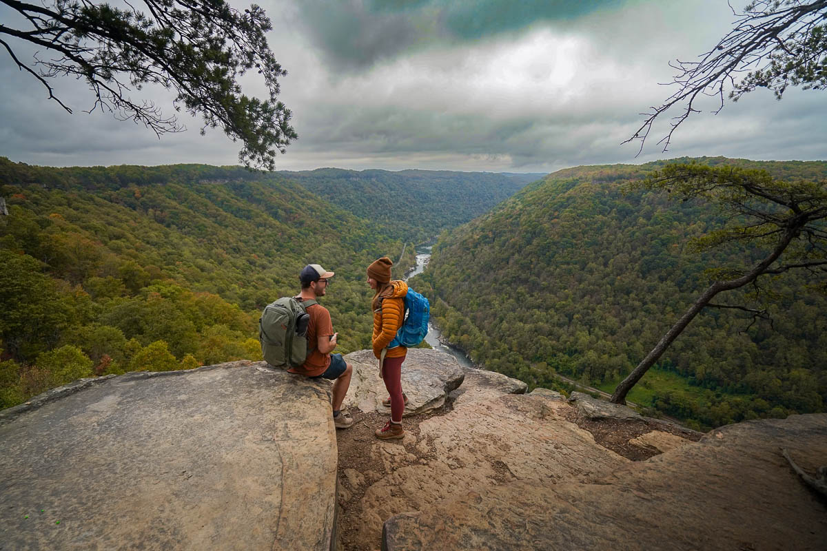 Couple sitting at the Diamond Point Overlook along the Endless Wall Trail in New River Gorge National Park in West Virginia