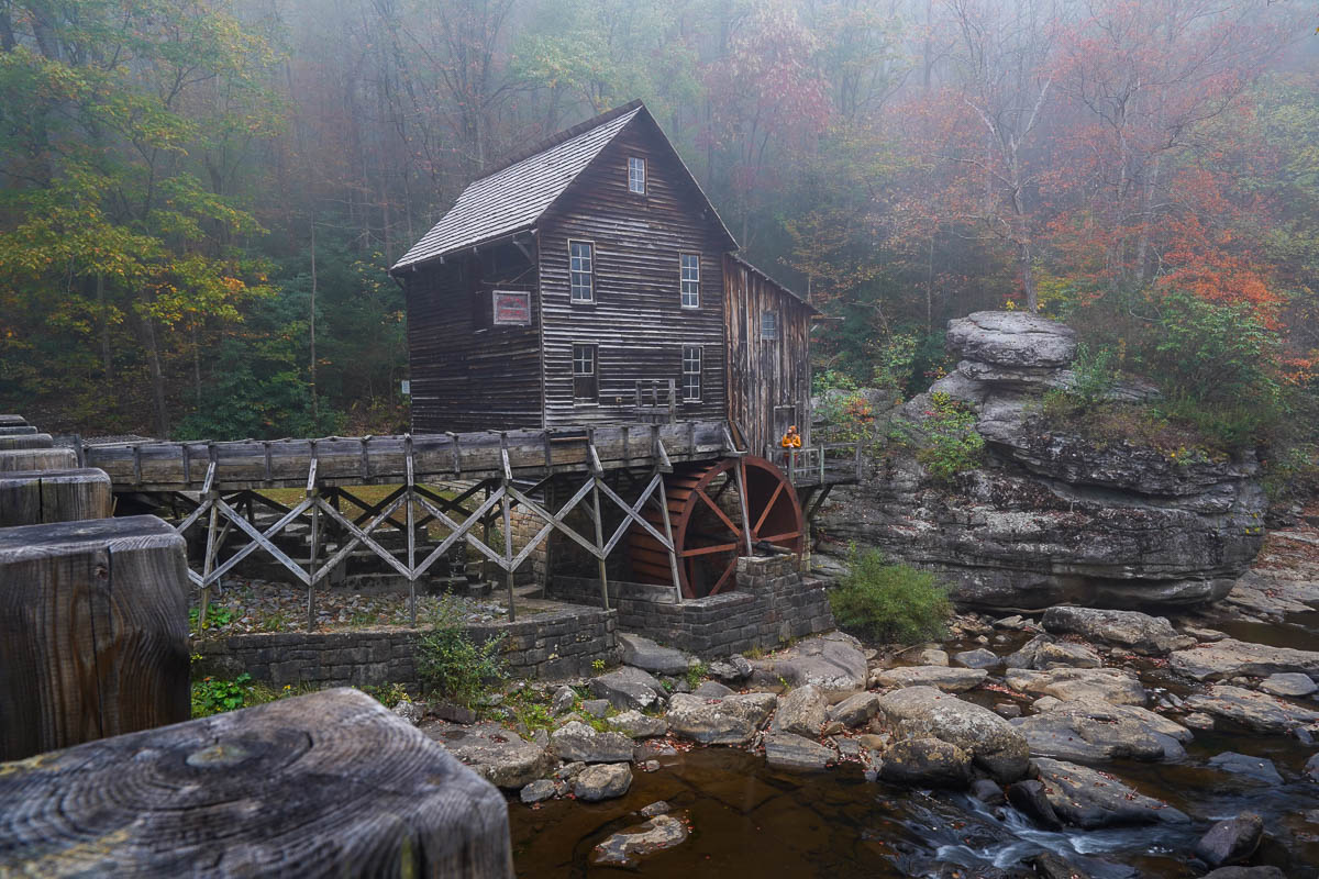 Woman standing on Glade Creek Grist Mill in Babcock State Park in West Virginia