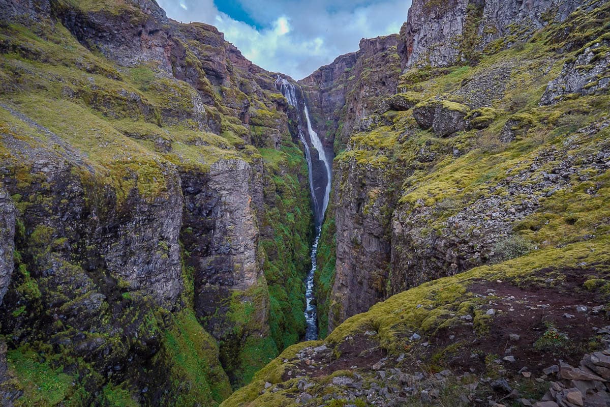 Glymur Waterfall cascading down a mossy canyon along the Glymur Waterfall hike in Iceland